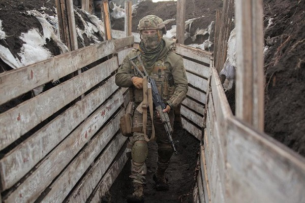 Một binh sĩ Ukraine mang theo vũ khí tuần tra dọc theo chiến tuyến giáp với khu vực do lực lượng ly khai kiểm soát ở miền Đông Ukraine ngày 6/4.