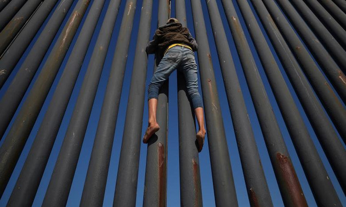 Di dân này cố trèo lên hàng rào biên giới Mỹ-Mexico ở Tijuana ngày 18/11.