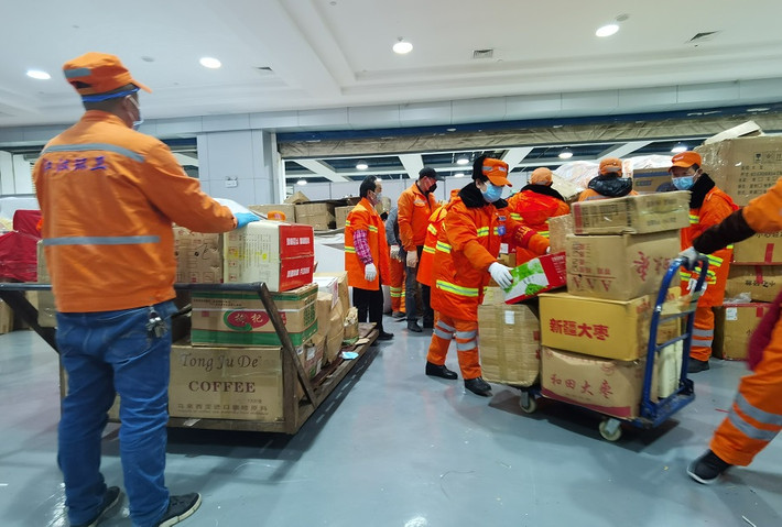 Các công nhân vận chuyển vật liệu xây dựng bệnh viện cabin di động tại Trung tâm Hội nghị và Triển lãm Quốc tế Vũ Hán.