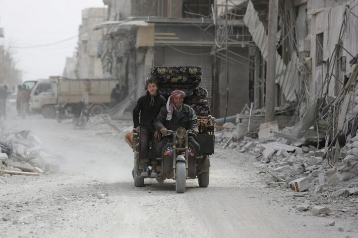 Một gia đình Syria chở đồ đạc đi trên con đường ở al-Bab hôm 2/3.