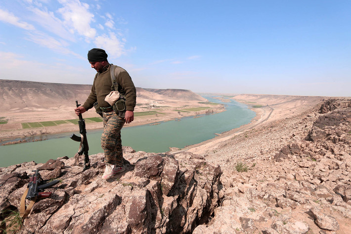 Một chiến binh thuộc Các Lực lượng Dân chủ Syria (SDF) đứng gần sông Euphrates, phía bắc thành phố Raqqa, ngày 8/3/2017.