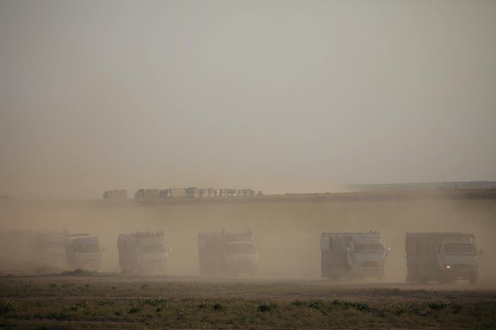 Những chiếc xe tải chở dân thường di chuyển gần ngôi làng Baghouz, tỉnh Deir Ezzor, ngày 25/2.