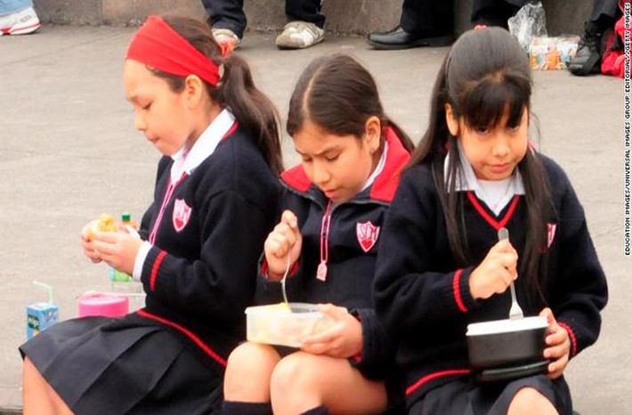 Các em nữ sinh ngồi ăn trưa ngoài trời ở Lima Peru. Đựơc biết, nhiều học sinh ở đây mang đồ ăn chuẩn bị từ nhà.