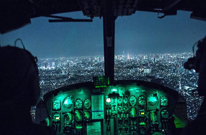Phi công Jonathan Bonilla và Vicente Vasquez ngồi trên chiếc máy bay UH-1N Huey bay qua bầu trời thủ đô Tokyo (Nhật Bản) sau khi hoàn thành chuyến bay huấn luyện vào ban đêm.