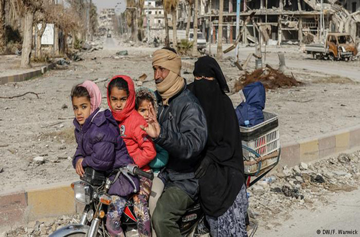 Một gia đình gồm 5 người ngồi chen chúc trên chiếc xe máy ở Raqqa.