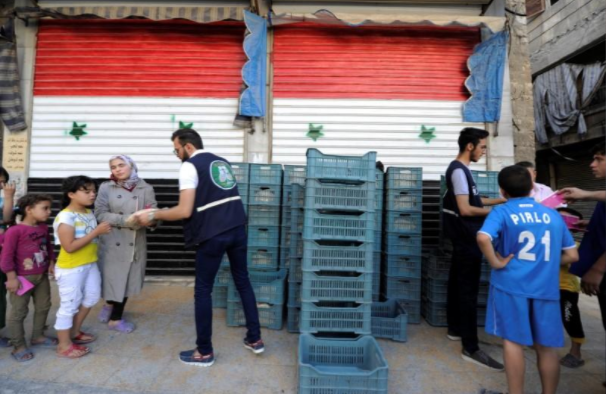 Người dân Syria nhận bánh mỳ được phân phát ở quận al-Kalasa ngày 13/7.