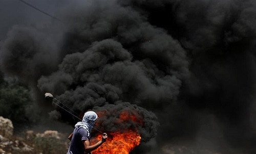 Cuộc đụng độ giữa người Palestine và lính Israel bùng phát ở ngôi làng Kurf Qadoon, gần thành phố Nablus, hôm 30/6 vừa qua. Ảnh: FNA.