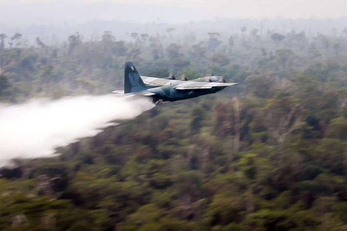 Một chiếc Hercules C-130 của Không quân Brazil đang thả nước để chữa cháy ở bang Rondonia, Brazil, ngày 25/8. Trong gần 50 năm qua, gần 1/5 diện tích rừng Amazon (hơn 770.000 km2) - bể chứa carbon lớn thứ hai Trái Đất chỉ sau các đại dương - đã bị đốn hạ và thiêu rụi ở Brazil. Ảnh: Không quân Brazil.