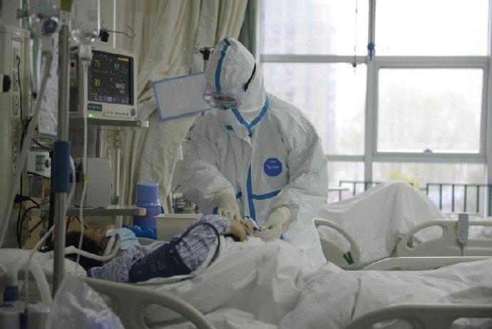 Nhân viên y tế điều trị cho một bệnh nhân nhiễm virus corona tại bệnh viện ở thành phố Vũ Hán. Ảnh: Reuters.
