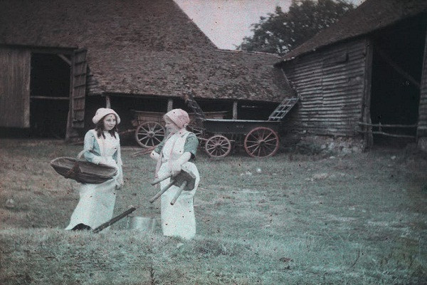 Hai nữ công nhân làm việc tại một trang trại năm 1915. Họ dường như là công nhân vắt sữa.