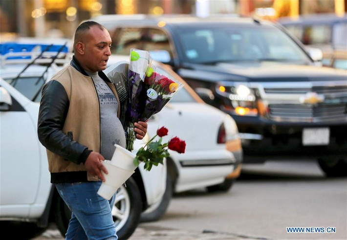 Một người đàn ông ôm bó hồng trên đường phố Baghdad, Iraq, trong dịp lễ Tình nhân Valentine năm nay. Ảnh: THX.