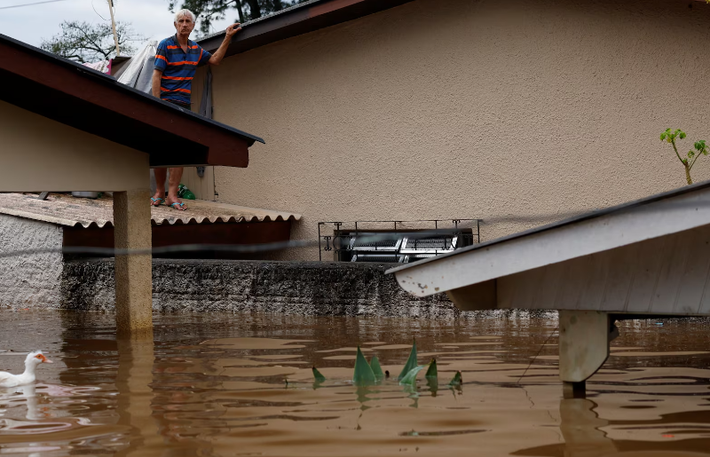 Julio Manichesque, 76 tuổi, đứng trên mái nhà sau lũ lụt ở Canoas, bang Rio Grande do Sul, Brazil, ngày 5/5.