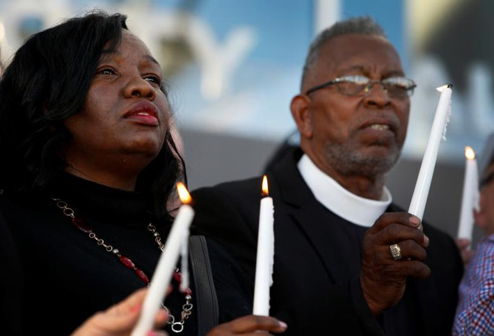 Tiffany Tyler (trái) và Pastor William McCurdy thắp nến cầu nguyện trước Tòa thị chính thành phố Las Vegas. Ảnh: Reuters.