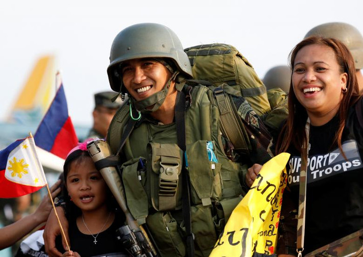 Một binh sĩ đoàn tụ với gia đình anh tại căn cứ không quân Villamor, thành phố Pasay. Ảnh: Reuters.