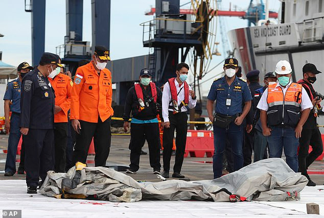 Lực lượng tìm kiếm cứu hộ sau đó chuyển các mảnh vỡ máy bay về cảng Jakarta. Các bộ phận thi thể được đưa đến bệnh viện để nhận dạng. Ảnh: AP.