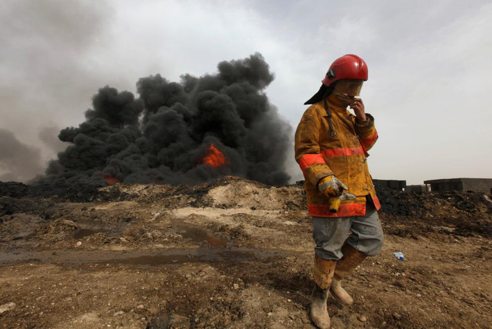 Khói đen bốc lên nghi ngút từ các giếng dầu bị đốt ở Qayyara hôm 1/11. (Nguồn ảnh: Reuters).