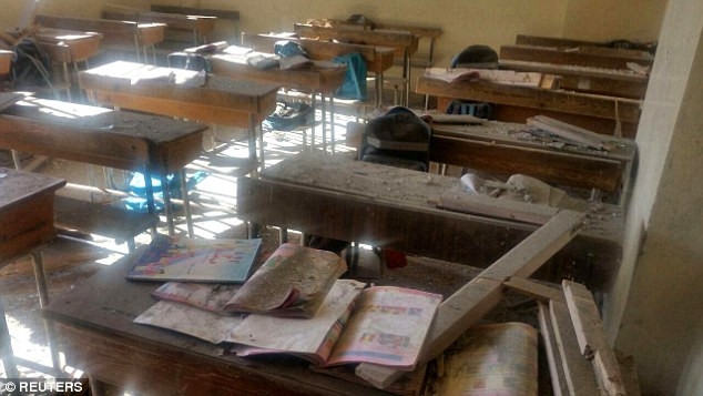 Sách vở, bàn ghế trong lớp học phủ đầy bụi. Ảnh: Reuters.