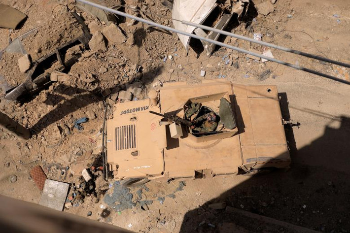 Một chiến binh SDF trên xe bọc thép tiến về căn cứ của phiến quân IS trong khu phố cổ ở Raqqa. Ảnh: Reuters.