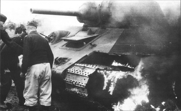 Lính Đức nhìn chiếc xe tăng T-34-76 đang bốc cháy. Ảnh: ER.