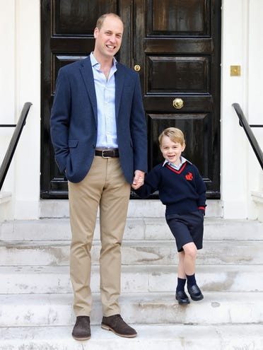 Tiểu Hoàng tử George tạo dáng cạnh cha, Hoàng tử William, tại Cung điện Kensington trước khi tới trường ngày 7/9/2017. Ảnh: Getty.