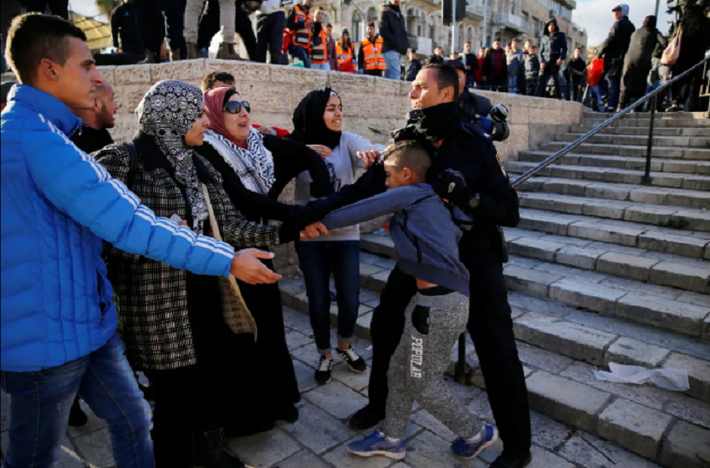 Cảnh sát Israel định bắt giữ một thiếu niên Palestine gần Cổng Damascus ở Thành phố cổ Jerusalem. Ảnh: Reuters.