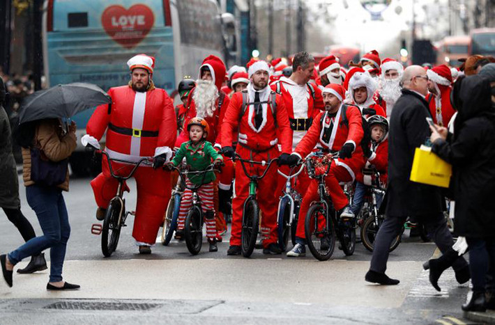 Cuộc đua xe đạp gây quỹ từ thiện của các ông già Noel trên phố Oxford, London, Anh. Ảnh: Reuters
