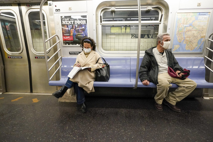 Hành khách đeo khẩu trang và giữ khoảng cách khi đi trên tàu điện ngầm ở New York ngày 9/3.