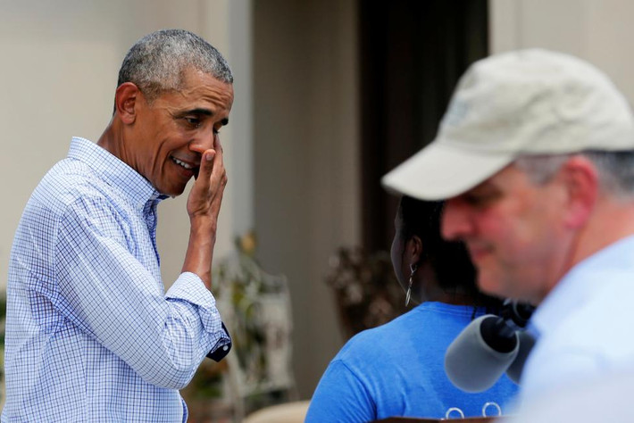 Tổng thống Obama lau mồ hôi trên mặt trong chuyến thăm các gia đình bị ảnh hưởng sau trận lũ lụt ở Louisiana hôm 23/8.