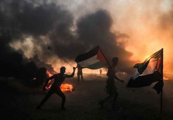 Người dân mang theo cờ Palestine khi tham gia cuộc biểu tình. Ảnh: FNA.