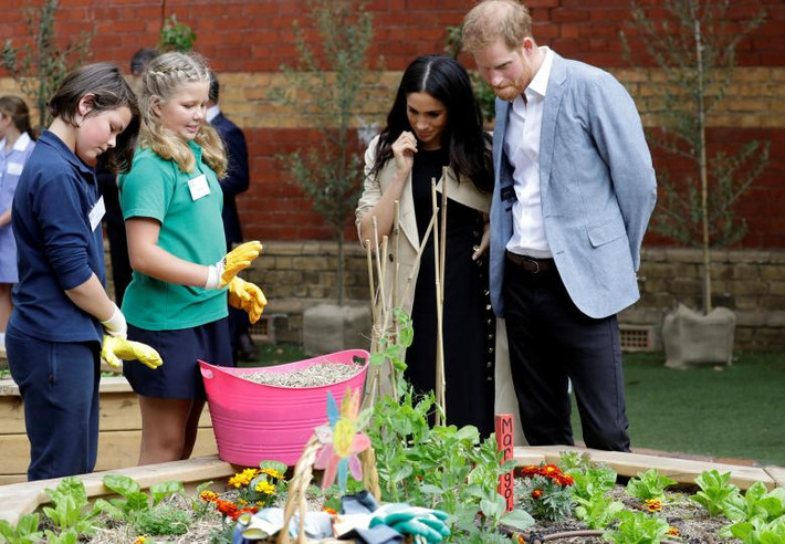 Hoàng tử Anh Harry và Công nương Markle trò chuyện với các em học sinh khi tới thăm trường tiểu học Albert Park ở Melbourne ngày 18/10.