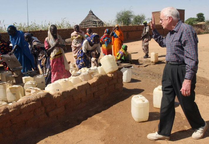 Ông Jimmy Carter vẫy chào những người phụ nữ tị nạn tại thị trấn Kabkbiya ở Bắc Dafur, Sudan, ngày 3/10/2007.