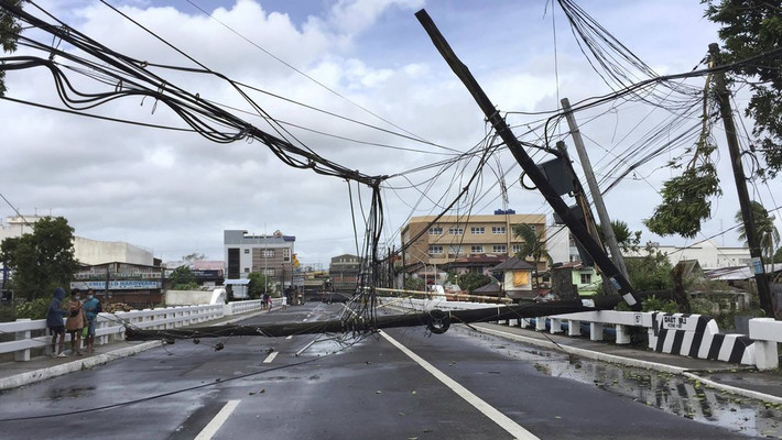 Cột điện gãy đổ ở Daet, tỉnh Camarines Norte, khi bão đi qua. Ảnh: AP.