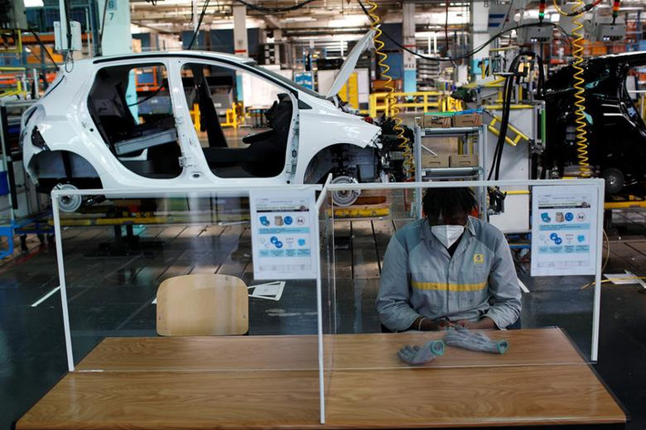 Người công nhân đeo khẩu trang ngồi nghỉ tại nhà máy ô tô Renault ở Flins, Pháp, ngày 6/5.