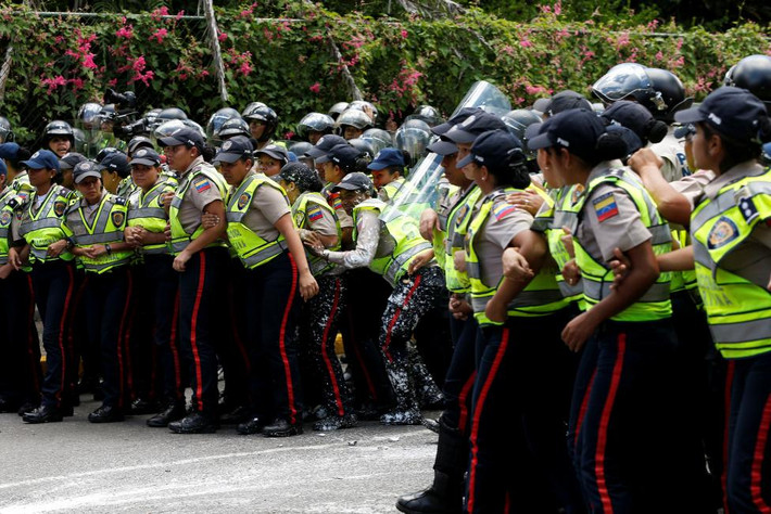Các nữ cảnh sát thiết lập hàng rào ngăn đám đông người biểu tình ở thủ đô Caracas ngày 9/6.