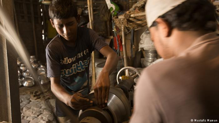 Trong ảnh là Ali Hossain, một lao động trẻ em nữa ở Bangladesh. Được biết, Ali làm việc trong nhà máy bạc ở Keraniganj hầu như cả ngày lẫn đêm. Công việc nặng nhọc trong nhà máy đang tàn phá sức khỏe của em. Ảnh: DW.