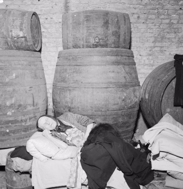 Một phụ nữ lớn tuổi ngủ trong hầm rượu ở Đông London năm 1940 do lo sợ những đợt không kích của phát xít Đức. Ảnh: VT.
