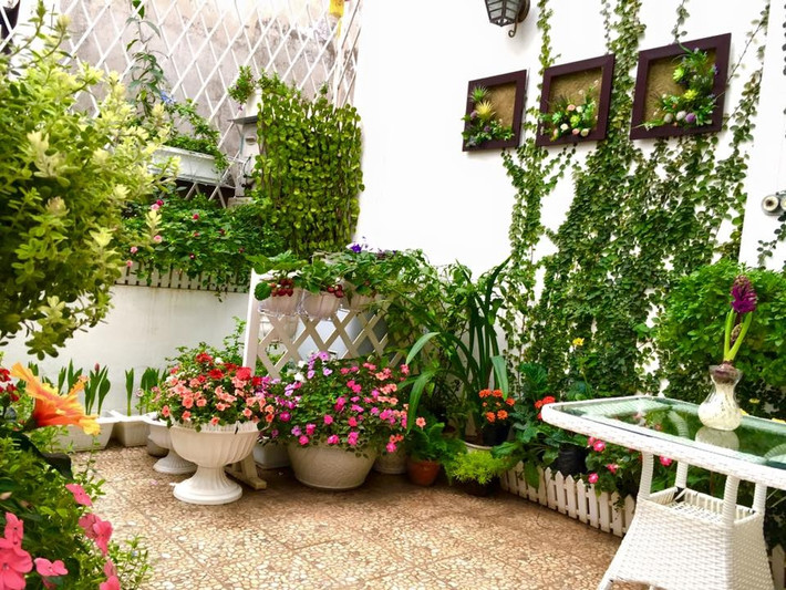 Sẽ không có gì đáng ngạc nhiên, khi chỉ với 15m2, chị Linh Chi đã biến khoảng diện tích nhỏ nhắn này thành khu vườn hoa xinh xắn, ấn tượng từ những chi tiết nhỏ nhất, bởi chị Chi vốn làm nghề thiết kế nội thất. Khoảng ban công tầng 4, nơi có nhiều ánh sáng tự nhiên nhất trong ngôi nhà đã được chị Linh Chi khéo léo thiết kế hàng rào treo những chậu cây, bên dưới được bố trí đặt những chậu hoa cỡ lớn và bộ bàn ghế xinh xắn.