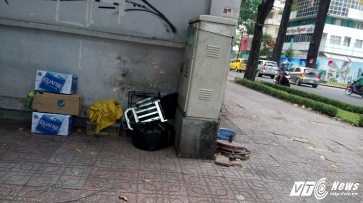 Một số hàng quán ven đường khác để đồ phía sau những trụ điện cao thế ven đường để không lấn vỉa hè.