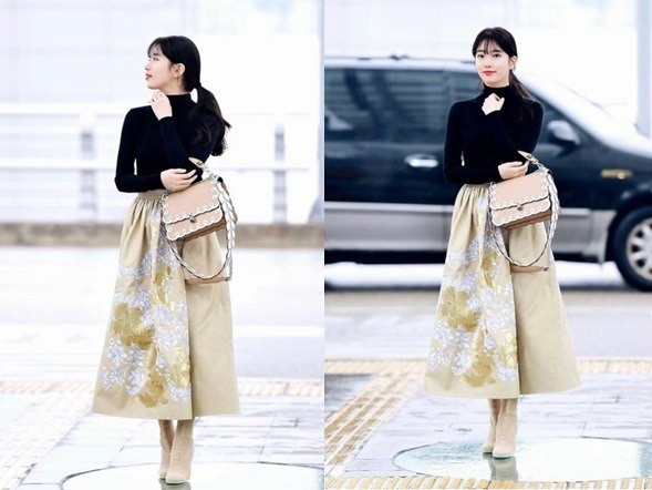 Trước đó, trang phục ra sân bay của Suzy được khen ngợi thanh lịch, nữ tính gồm áo thun và chân váy midi.
