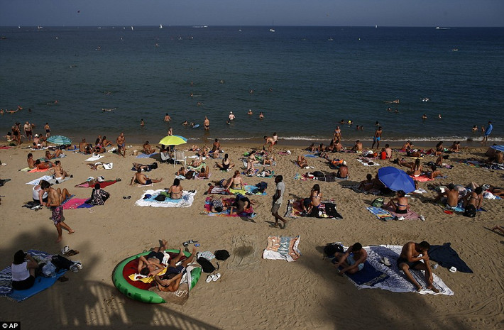 Các bãi biển ở Barcelona chật kính người trong đợt nắng nóng như thiêu như đốt này.