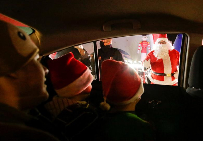 Các em nhỏ gặp "ông già Noel" qua cửa kính ô tô, tại một ngôi làng Giáng sinh ở Ciudad Juarez, Mexico, hôm 3/12.