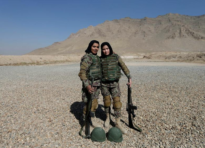 Trong ảnh: Hai nữ binh sĩ Quân đội Quốc gia Afghanistan (ANA) là Mohazama Najebi, 18 tuổi, và Sahar Ibrahimi, 25 tuổi, "tạo dáng" trước ống kính sau bài tập bắn súng tại Trung tâm huấn luyện quân sự Kabul (KMTC) ở thủ đô Kabul, Afghanistan, ngày 26/10/2016. (Nguồn ảnh: Reuters)