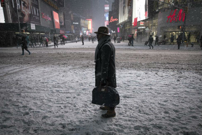Người đàn ông đứng giữa trời tuyết rơi ở Quảng trường Thời đại, New York ngày 26/1/2015.