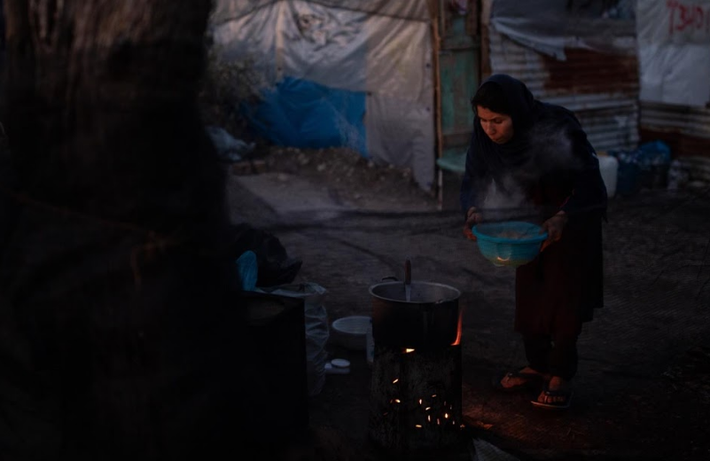 Cô Yasamin nấu ăn bên ngoài lán trại.