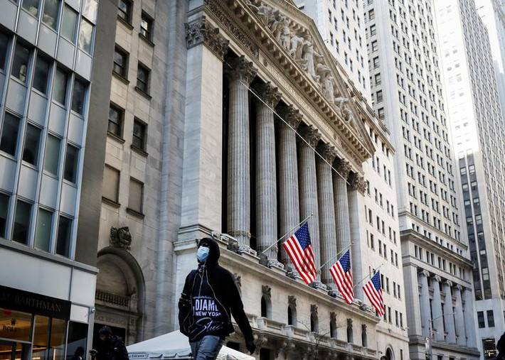Người đàn ông đeo khẩu trang khi đi bộ gần Sở giao dịch chứng khoán New York hôm 2/3.