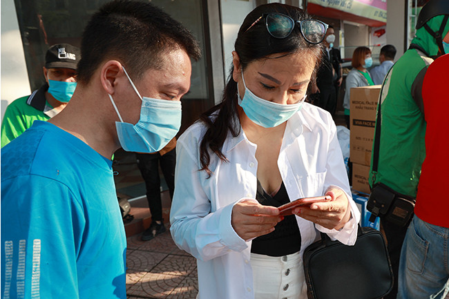 Những người đến nhận quà chỉ cần đưa điện thoại ra để chị Thành và nhóm thiện nguyện xác định là người có hoàn cảnh khó khăn thì sẽ được nhận quà hỗ trợ.