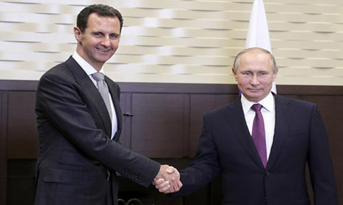 Tổng thống Putin bắt tay người đồng cấp Syria Bashar al-Assad hôm 20/11. Ảnh: AP.