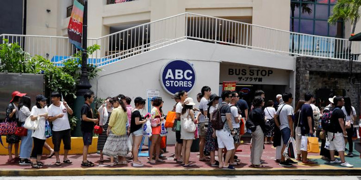 Rất đông du khách xếp hàng chờ xe buýt tại quận Tumon. Baumgartner, một quản lý tại cửa hàng thời trang, chia sẻ: “Tôi rất tin tưởng rằng Mỹ sẽ bảo vệ chúng tôi”. Ảnh: Reuters.