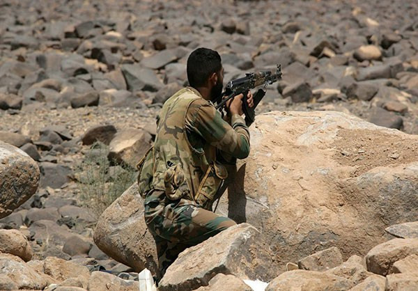 Một binh sĩ Syria ngắm bắn khủng bố IS trên chiến trường. Ảnh: FNA.