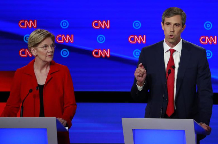 Thượng nghị sĩ Warren đứng nhìn ứng viên Beto O'Rourke tại buổi tranh luận đêm 30/7.